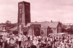 Toned photograph of church and yard circa 1930.