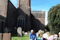 Project volunteer Bob resting after clearing foliage off of stones.